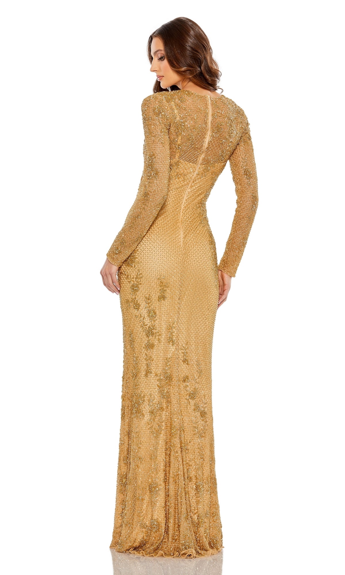 A woman stands with her back to the camera in a Mac Duggal 5504 long gold beaded formal gown, featuring intricate embroidery, against a plain white background.